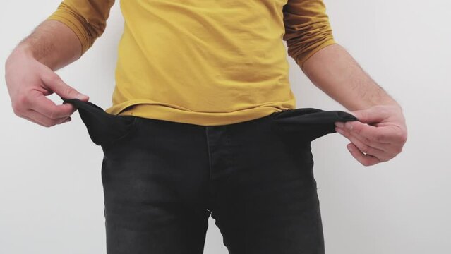 Man showing empty pocket, no money, broke and other financial issues.