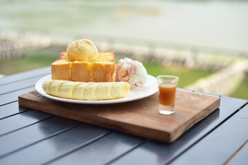 Honey toast with banana on white plate.