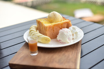 Honey toast with banana on white plate.