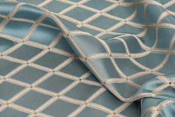 Gray silk fabric with textured geometric pattern. Rhombus fabric background