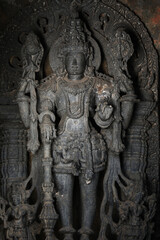 Fototapeta premium Stone Sculpture of Hindu Gods with selective focus, 12th century Hindu temple, Ancient stone art and sculptures in each pillars, Chennakeshava Temple, Belur, Karnataka, India.