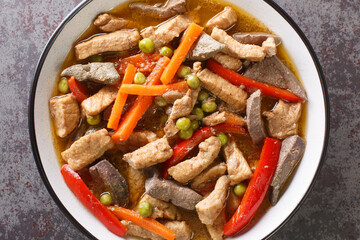 Igado Pork and Liver Ragout Asian Food closeup in the plate on the table. Horizontal top view from above