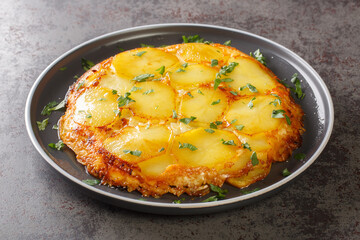 Pan haggerty is a simple one pot, stove top dish made with potatoes, onion and cheese closeup in the plate on the table. Horizontal