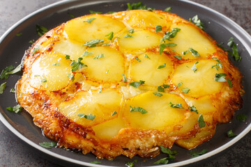 English potato casserole Pan haggerty close-up in a plate on the table. horizontal