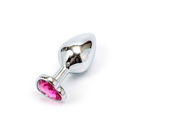 Metal butt plug with a decorative pink heart-shaped stone at the end.