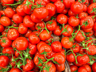 tomatoes on a green branch cherry tomato fruits on the counter of the market store healthy meal food diet snack on the table copy space food background rustic top view keto or paleo diet veggie vegan
