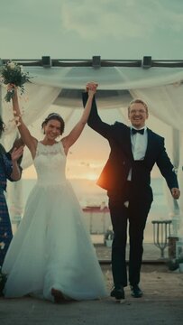 Vertical Screen: Beautiful Bride and Groom During an Outdoors Wedding Ceremony on a Beach Near the Ocean. Marriage Venue for Romantic Couple and Best Friends with Multiethnic Diverse Cultures.