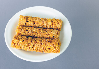 breakfast cereal bars with vitamins on a plate, top view