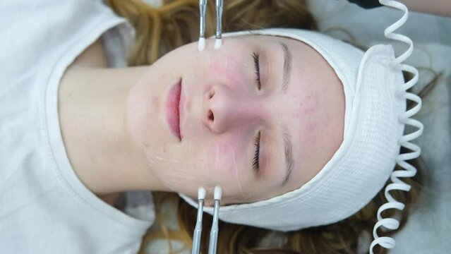 Cosmetic procedure to improve the condition of the skin of the face with microcurrents. Cosmetology and professional facial skin care.