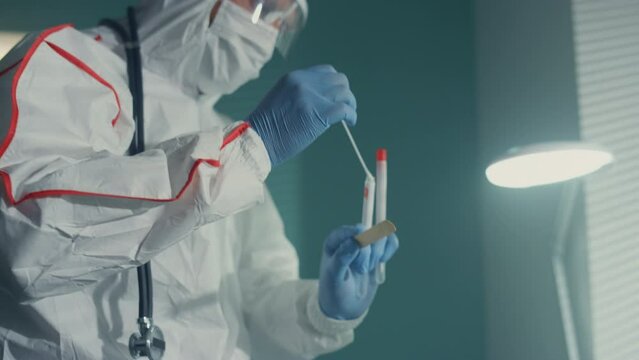Doctor taking covid swab in ward closeup. Specialist work in infectious unit.