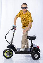 Fototapeta na wymiar guy in an electric car. a man in the studio on a tricycle. White background. electric scooter