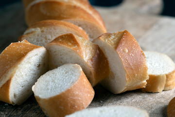 wheat baguette cut into pieces on a cutting board