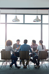 The round table of great ideas. Shot of a group of coworkers having a brainstorming session in an office boardroom.