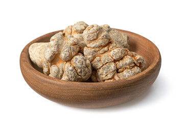 Dried notoginseng roots in the wooden bowl, isolated on the white background.