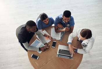 The best doctor is the one you run to and cant find. Shot a group of doctors discussing work matters in the office at work.