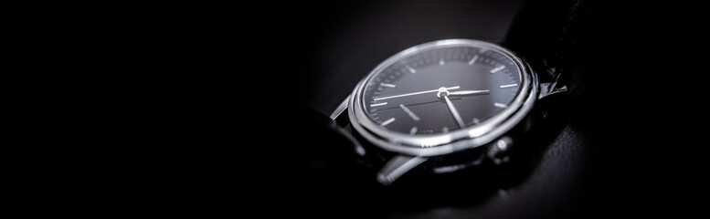 Quartz wristwatch with black dial close-up