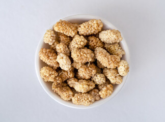 Close up photo of dried raw mulberry on isolated background. 