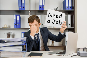 workaholic auditing accountant is tired at his work after a lot of overworked and holding a paper...