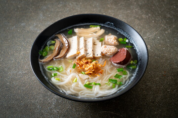 Vietnamese Rice Noodles Soup with Vietnamese Sausage served vegetables and crispy onion