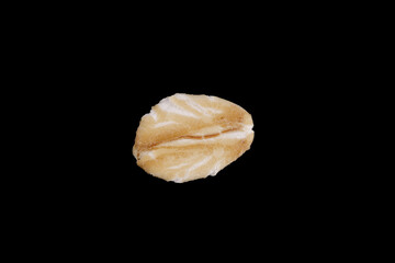 natural oat flakes isolated on black background