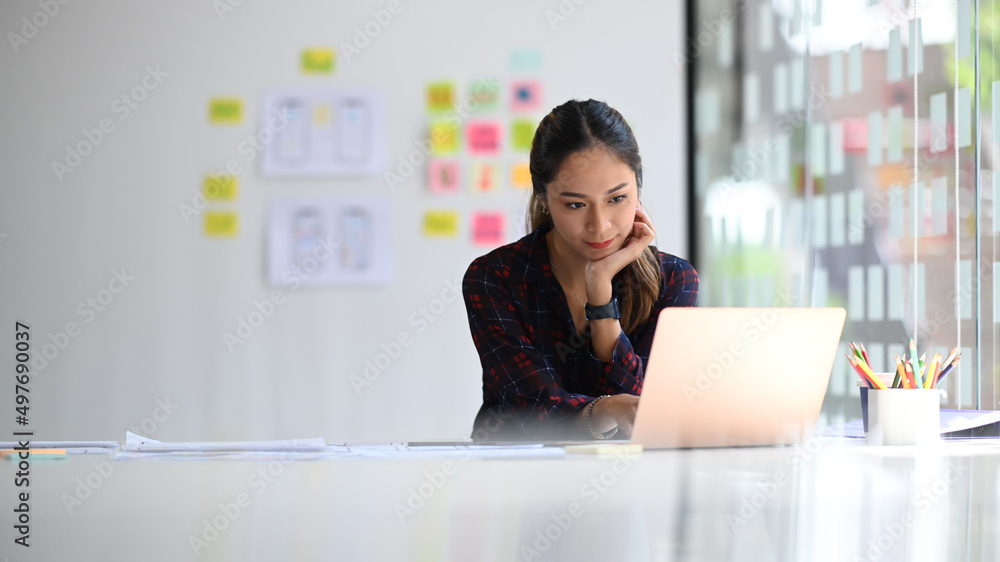 Poster concentrated female web developer working on mobile application software design project at modern wo