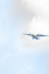 The plane is about to land on the runway with a bright blue sky background. Travel background. Passenger airliner. Business trip. Commercial aircraft. copy space for aviation and air transportation. 