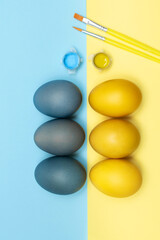 Easter eggs are folded in two lines on a yellow and blue background, Ukrainian patriotism, a set for creativity from paints and a brush