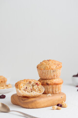 Muffins in a wooden plate on a white table