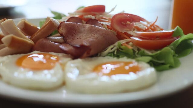 English breakfast - eggs, bacon and vegetables with juice