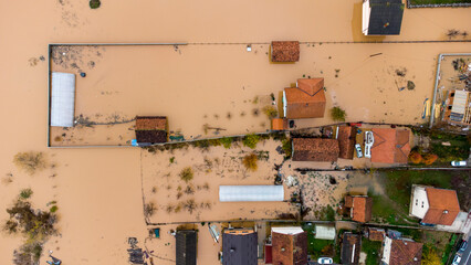Aerial drone view of torrential rain causes flash floods in residential areas. Houses and roads...