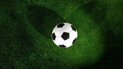 Naklejka premium Soccer ball placed on grass, top shot.