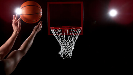 Basketball going through the basket on black backgorund