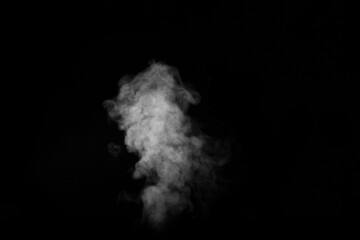 Curly white steam rising up and splashing water scattering in different directions isolated on a black background. Evaporation of liquid and condensation. Can be used as background, design element
