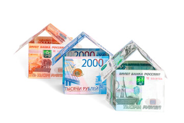 Houses made of ruble notes of different denominations, isolated on a white background