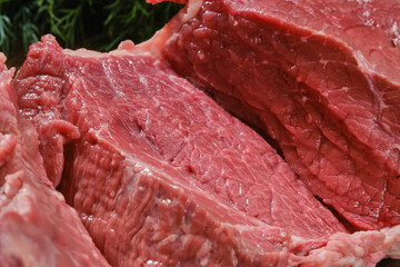 Raw beef meat on a cutting board. Cut out of raw beef fillet. Shallow depth of field	