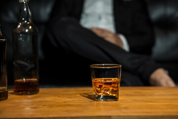 Closeup businessmen holding a glass of whiskey