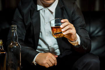 Closeup businessmen holding a glass of whiskey