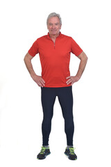 front view of a senior man with sportswear hands on hip on white background