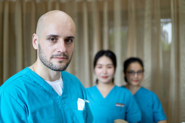 Team of happy stomatologists in dentist's clinic.