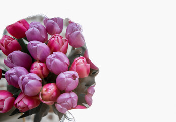 Double exposure, face portrait of young beautiful woman and spring flowers tulips. Beauty, femininity, sensuality, mystery, dreams. Place for text. Floral fantasies