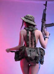 naked sexy female soldier in military unloading and military hat on a neon background with a...