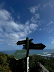 Hiking trail signs on Table Mountain, Cape Town, on a cloudy day.