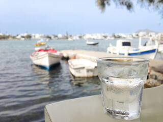 Cold drink by the sea with small boats in the harbour