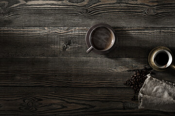 A cup of coffee and coffee beans on the table. .