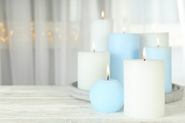Fototapeta na wymiar Concept of relaxation with aroma candles, space for text