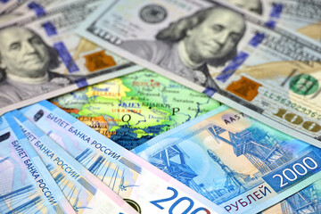 Russian rubles and US dollars on map of Ukraine. Concept of american support for Kiev during special military operation of Russia