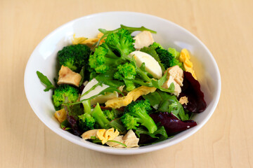 Healthy salad with chicken, egg, broccoli and mozzarella