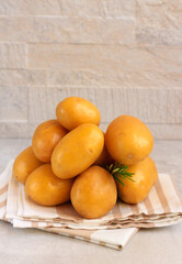 Raw potatoes with rosemary over kitchen towel