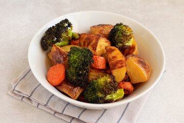 Roast vegetables: potato, carrot, broccoli in a bowl