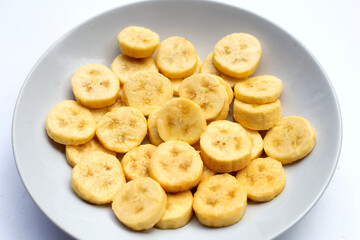 Banana slices in white plate